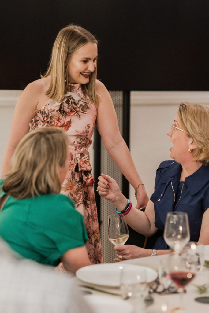 CEO talking to guests sitting on their table