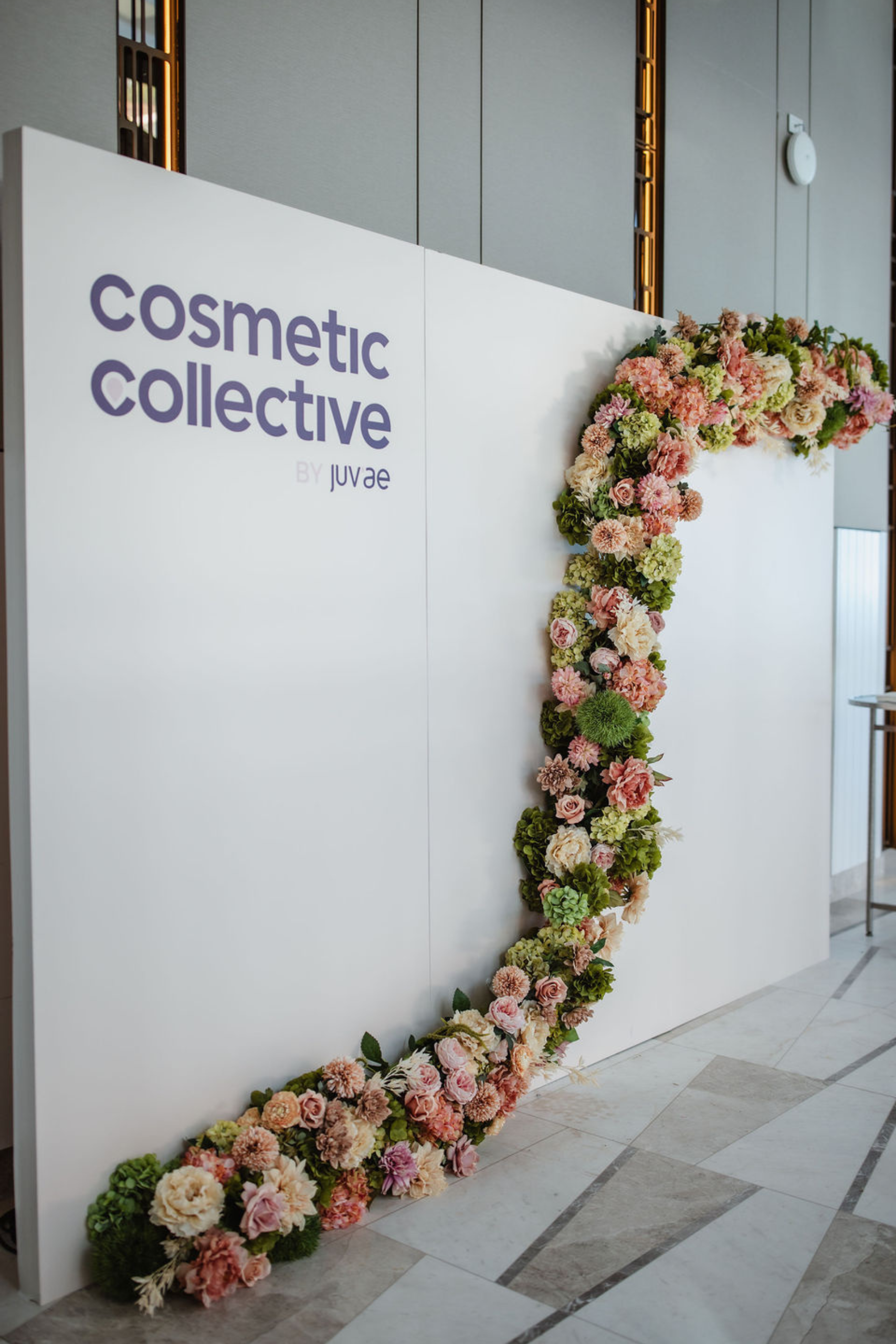 Close up of Juv'ae media wall at the Cosmective Collective conference 2025