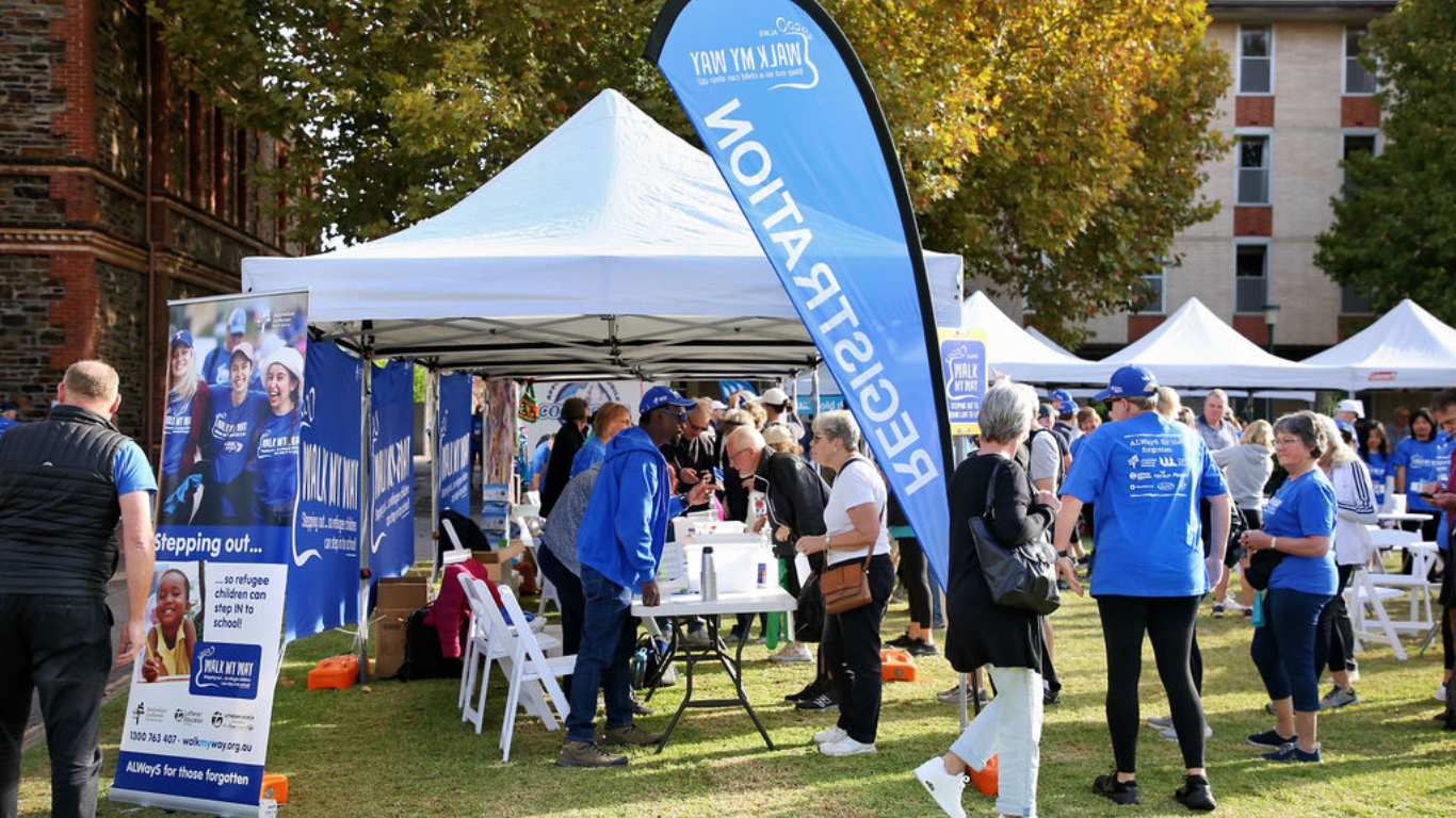 People registering for event attendance at registration desk